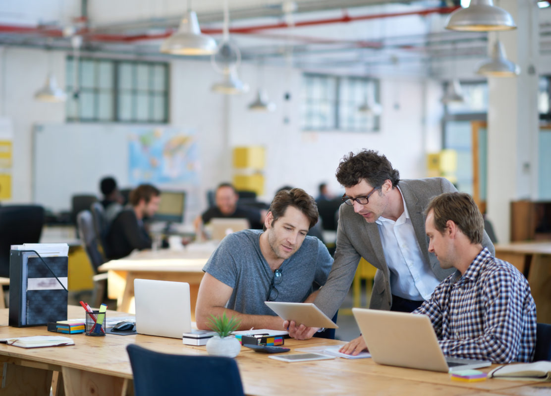 Photo of employees collaborating in office