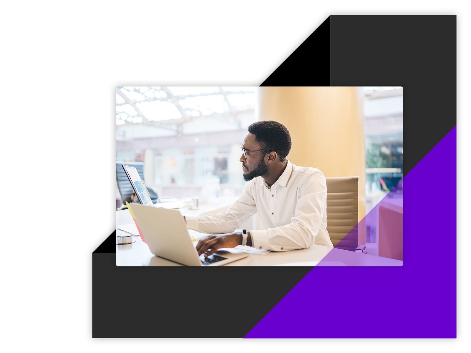 Man in an office - working on his laptop