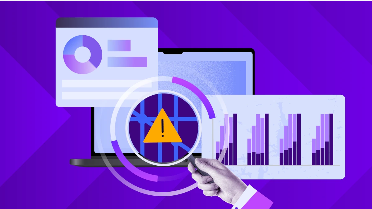 Security analytics displayed on a laptop with charts and a warning icon under magnification, representing ransomware detection and risk monitoring.
