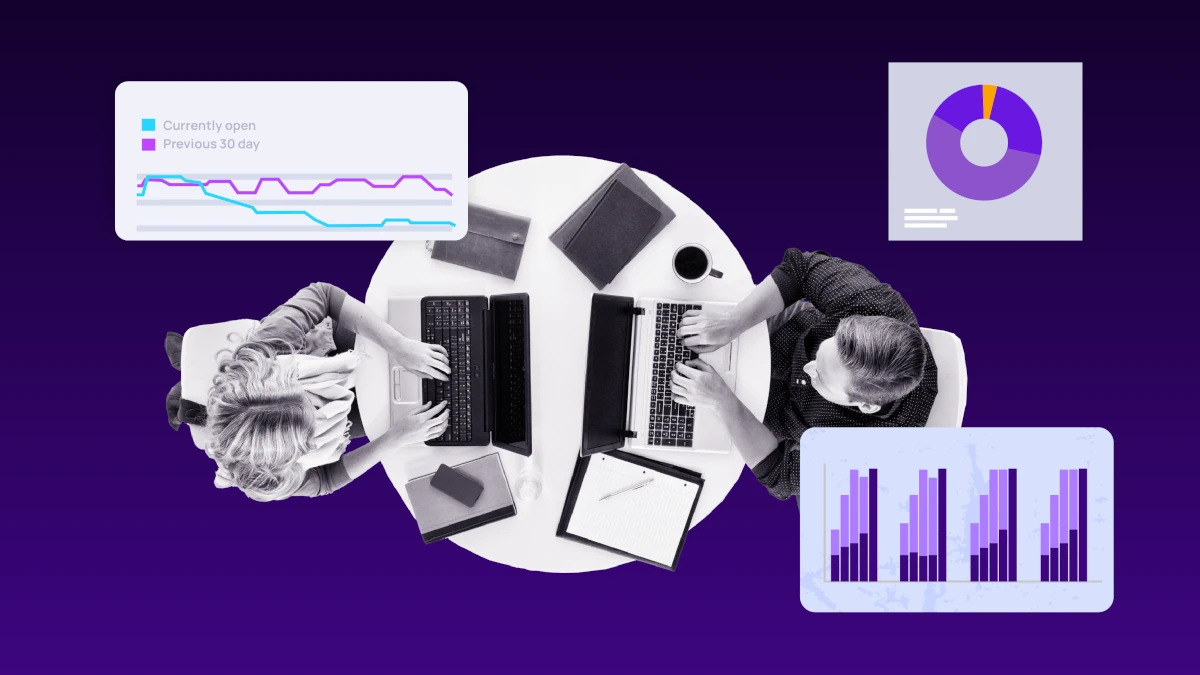 Top‑down view of two people working on laptops at a round table, surrounded by charts and graphs representing security and performance analytics.